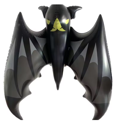 Inflatable bat-shaped object with yellow eyes on a white background