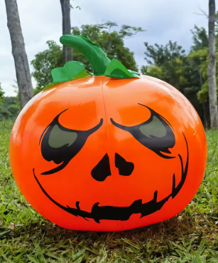  inflatable pumpkin with a carved face on grass