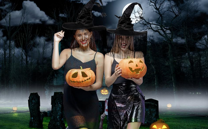 Two women in Halloween costumes holding pumpkins against a dark, eerie background with trees and tombstones.