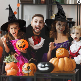 Group of people in Halloween costumes with pumpkins and decorations.
